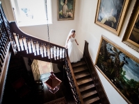 Bride descends stairs at Smedmore House